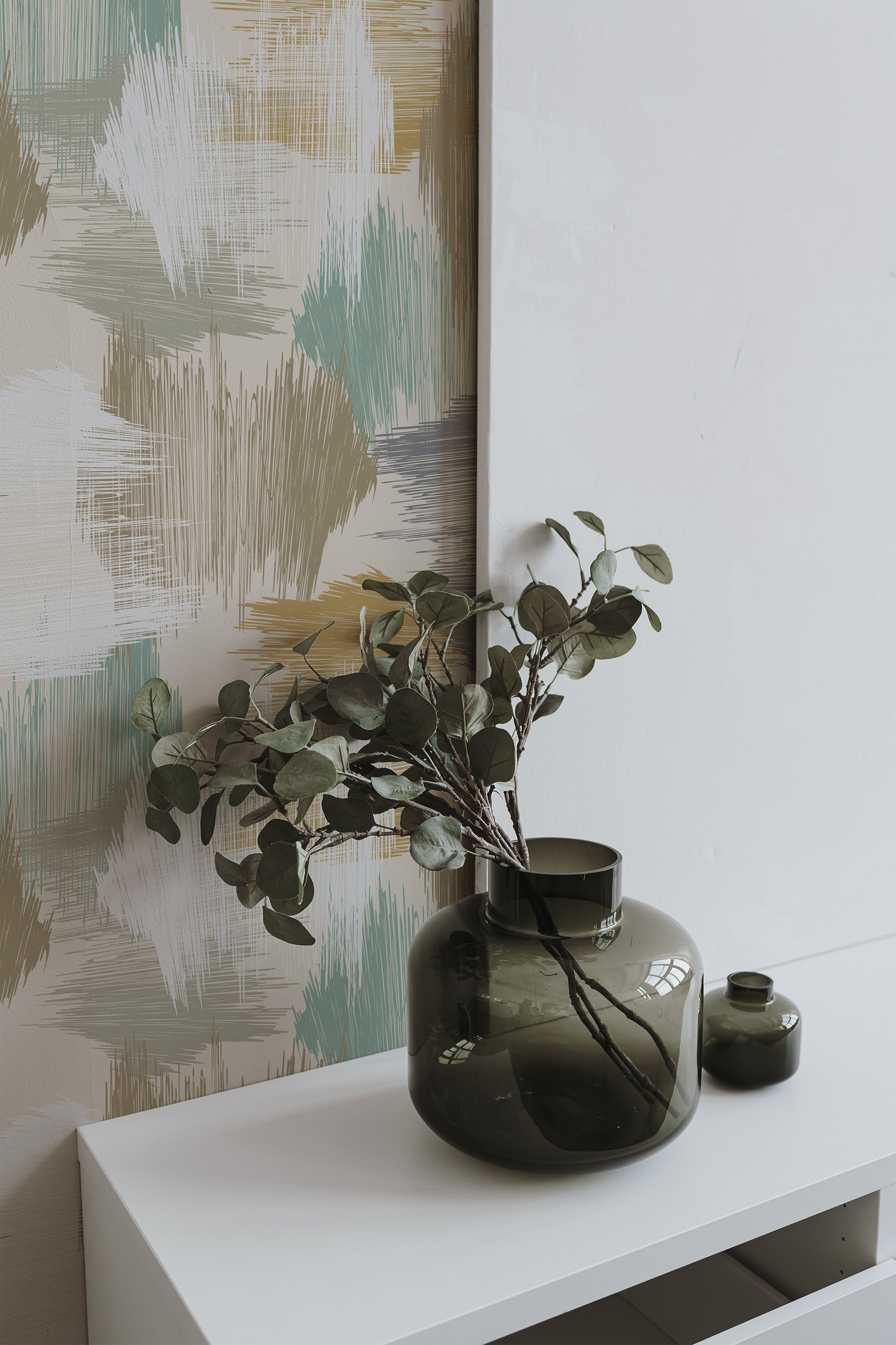 Self-adhesive earthy artwork wallpaper with abstract brushstroke patterns in soft tones of green, beige, and yellow, creating a calming and natural atmosphere.