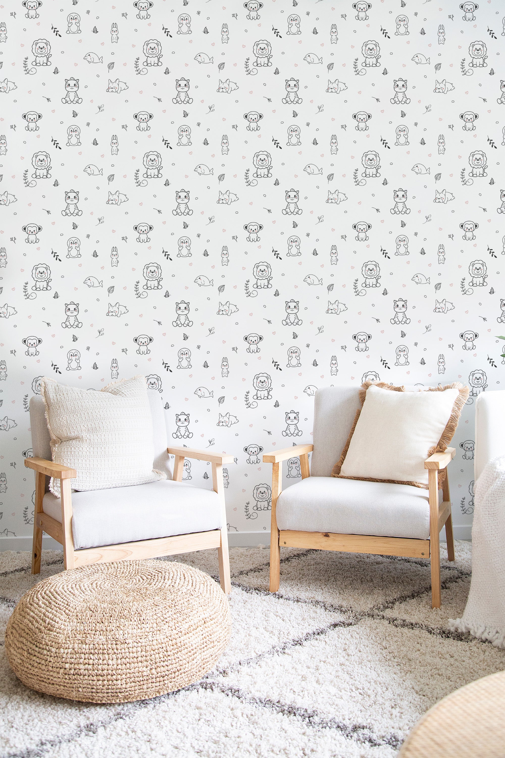 Wallpaper with a pattern of small, hand-drawn animals like bears, birds, and foxes in soft pastel colors, scattered across a white background, creating a light and whimsical feel. Traditional wallpaper.