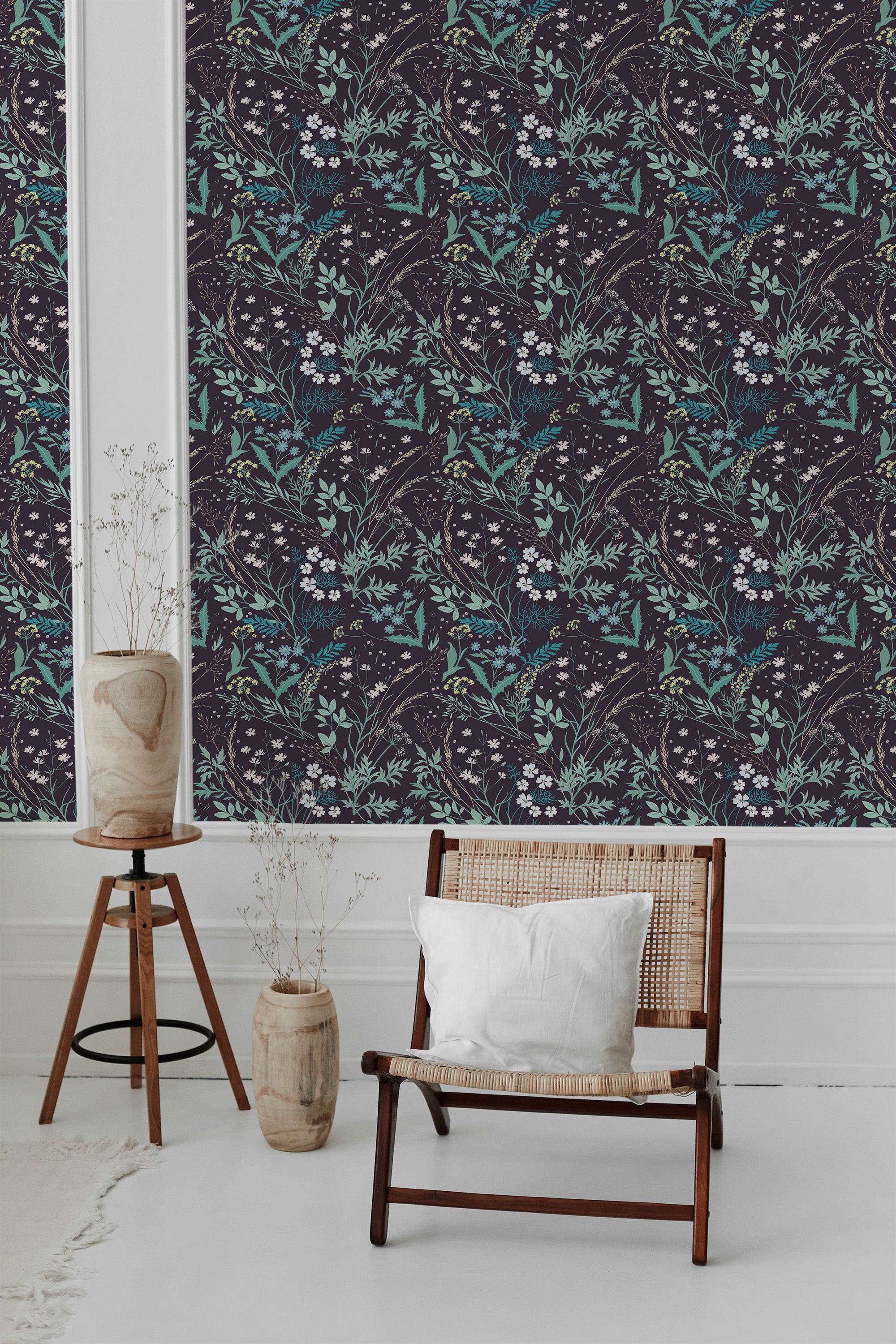The wallpaper has a rich, dark background adorned with intricate, large floral patterns in shades of teal and white, creating a lush and elegant tropical feel with a touch of vintage charm. The overall look adds depth and texture to the space, enhancing the classic ambiance of traditional wallpaper.