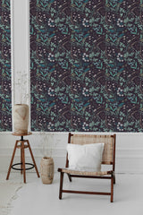 The wallpaper has a rich, dark background adorned with intricate, large floral patterns in shades of teal and white, creating a lush and elegant tropical feel with a touch of vintage charm. The overall look adds depth and texture to the space, enhancing the classic ambiance of traditional wallpaper.