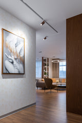 Subtle line art of a woman's body in a minimalist style, repeated across the wall in soft, neutral tones, complementing the modern interior with warm wood accents and soft lighting, traditional wallpaper.