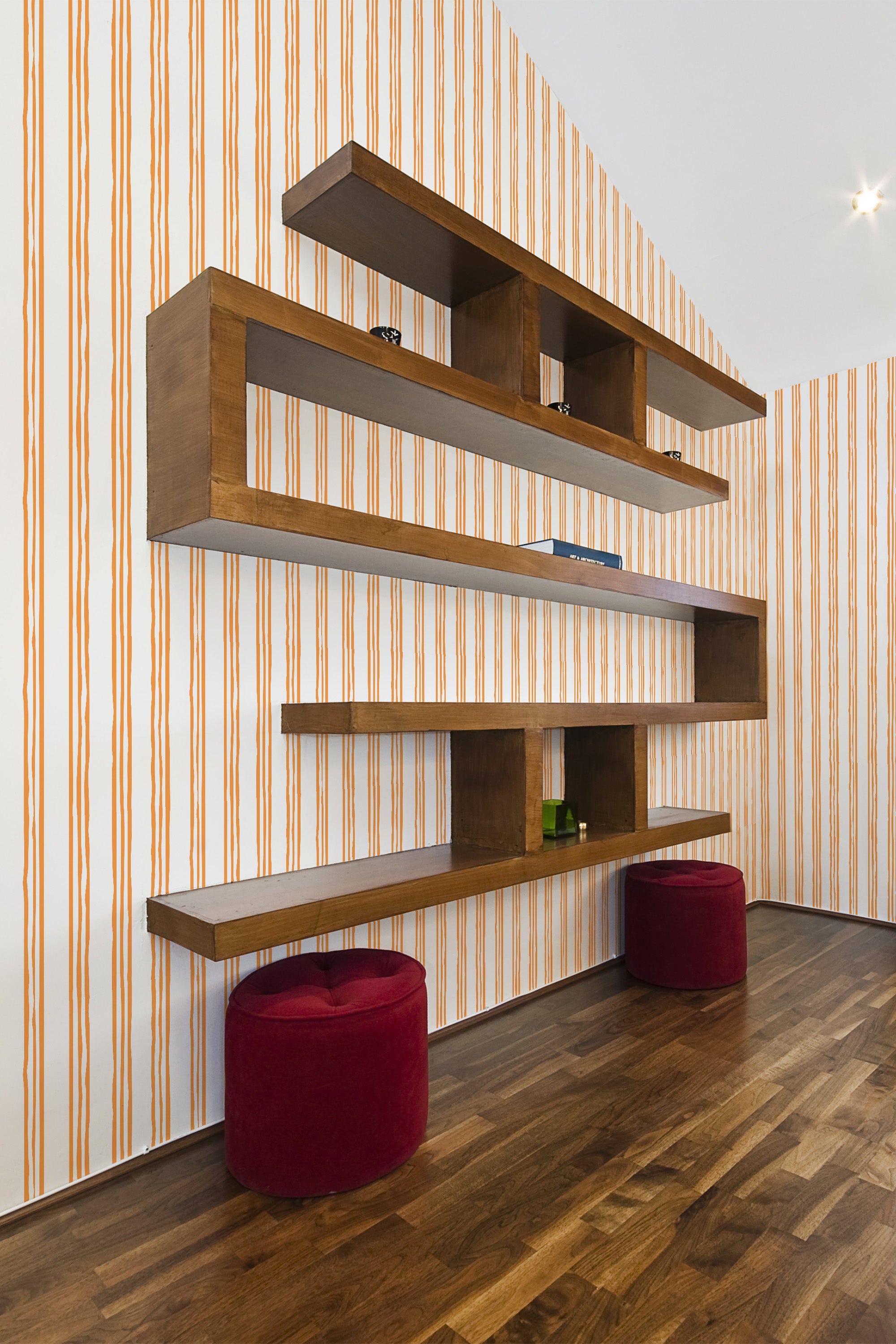 A room with wallpaper adorned with vertical orange and white stripes in a simple pattern, adding a touch of Aesthetic design to the space. Traditional wallpaper.