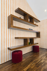 A room with wallpaper adorned with vertical orange and white stripes in a simple pattern, adding a touch of Aesthetic design to the space. Traditional wallpaper.