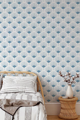 Self-adhesive wallpaper with a pattern of stylized abstract leaves in blue and cream tones, arranged in a repeating geometric pattern.