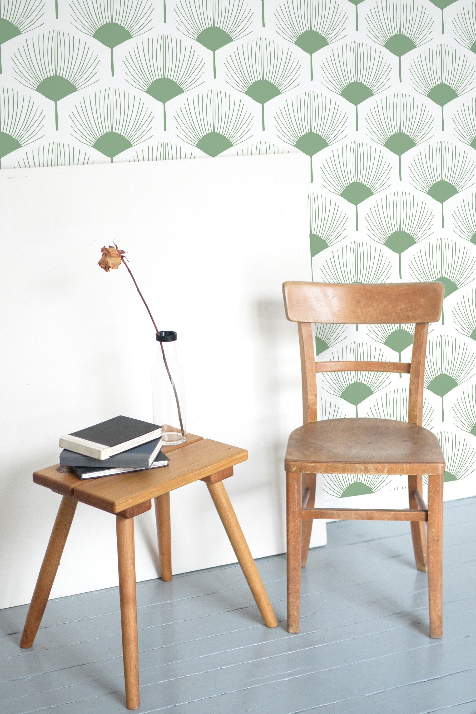 Self-adhesive abstract floral wallpaper with a repeating pattern of green fan-shaped leaves on a white background.