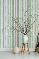 Self-adhesive wallpaper with a vertical pattern of three parallel lines in alternating shades of green against a light background.