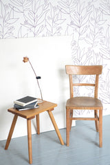 Self-adhesive wallpaper with a large floral design in a minimalist outline style, featuring delicate botanical patterns with leaves and small berries on a white background.