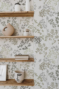 Self-adhesive wallpaper with an elegant floral design, comprising delicate green and gray leaves accompanied by small clusters of soft, muted flowers.