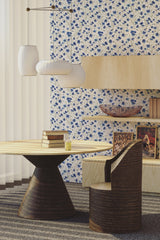 Blue floral print wallpaper with delicate, intricate flowers scattered across a white background, adding a soft, elegant touch to the room���s decor, a traditional wallpaper.