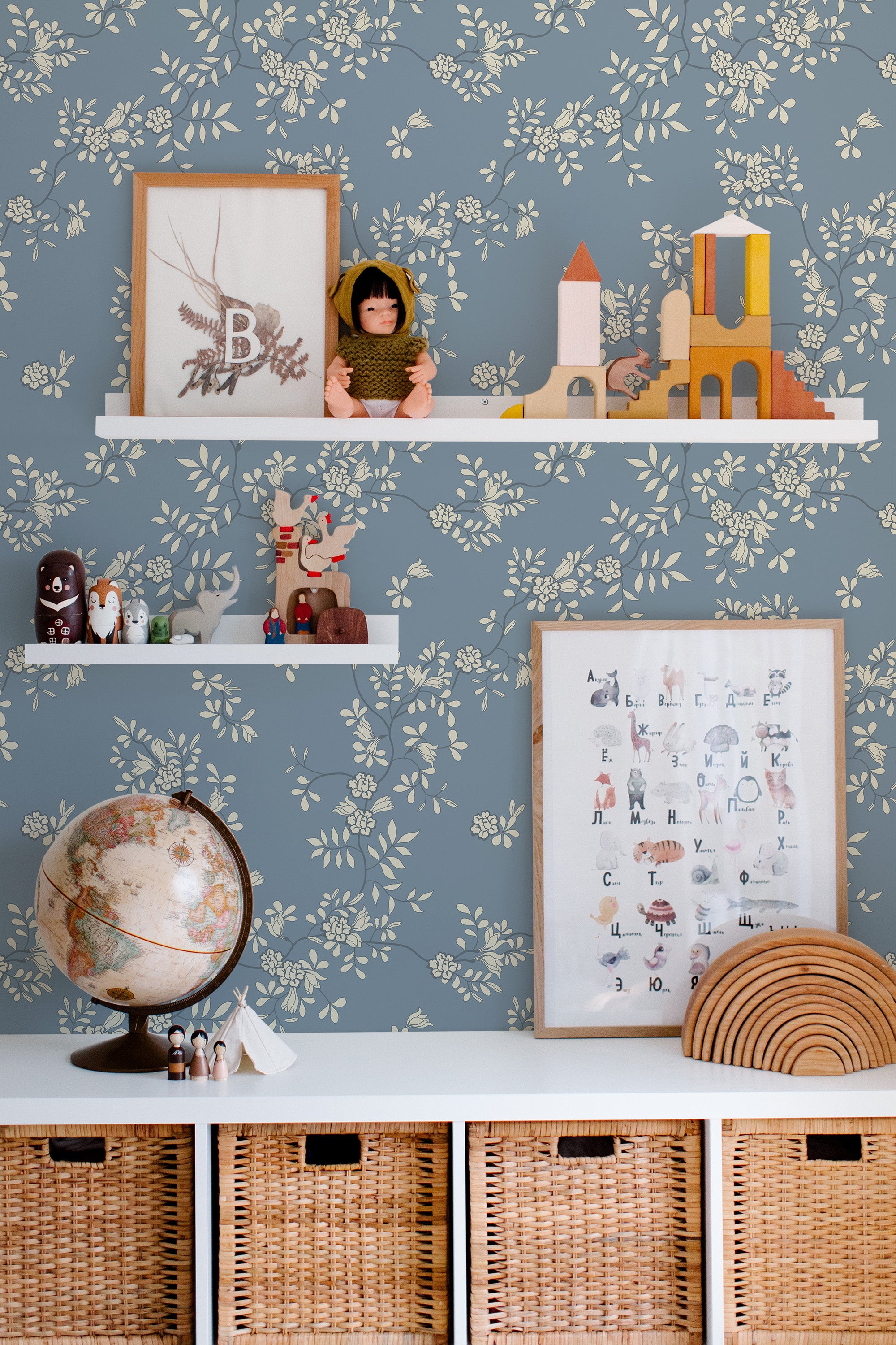 Self-adhesive wallpaper with a Garden design featuring delicate cream-colored floral patterns on a soft blue background, creating a serene, nature-inspired aesthetic.