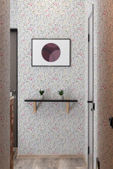 Floral wallpaper with a delicate pattern of small flowers and green leaves on a light background, creating a soft and traditional wallpaper.