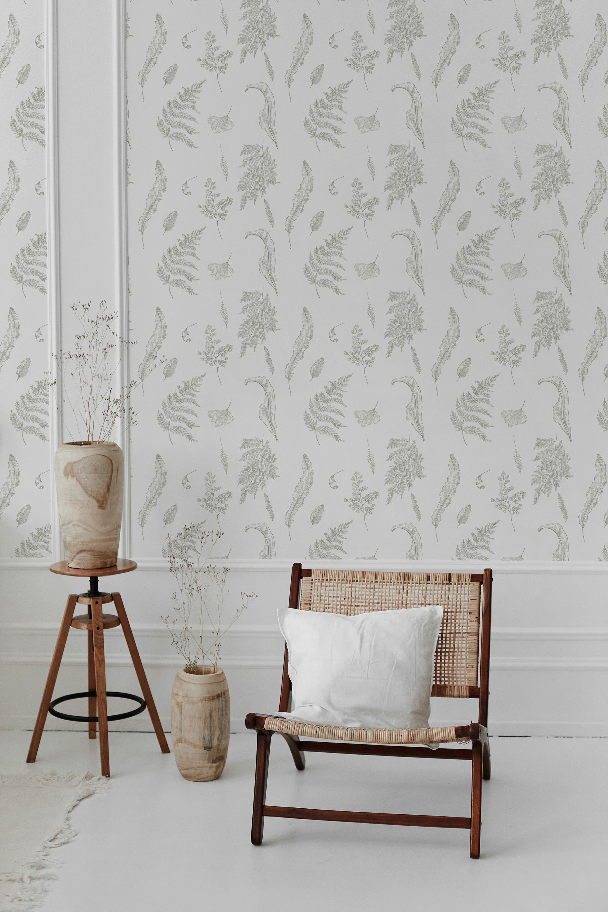 Wallpaper with a delicate pattern of fern leaves in soft, natural green tones, creating a subtle, organic look against a white background. Traditional wallpaper.