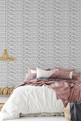 Black continuous wavy lines on a white background creating an intricate and modern abstract pattern for a traditional wallpaper.