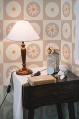 Self-adhesive wallpaper with a retro design of alternating squares in muted tones, each containing a minimalist white daisy with a yellow center.