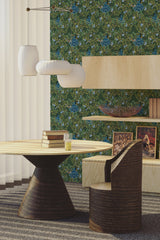 The wallpaper design has vibrant blue peacocks surrounded by intricate golden patterns and lush green foliage, creating an elegant and ornate atmosphere. The peacocks are detailed with feathers fanned out, nestled among flowers and leafy vines, all set against a deep green background. This traditional wallpaper.