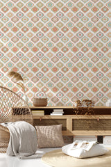 Pastel retro flower pattern with interconnected geometric shapes in soft hues of pink, beige, and mint on a light background, creating a subtle vintage aesthetic. The room includes a rattan chair, a wooden console table, and cozy decor complementing the traditional wallpaper.
