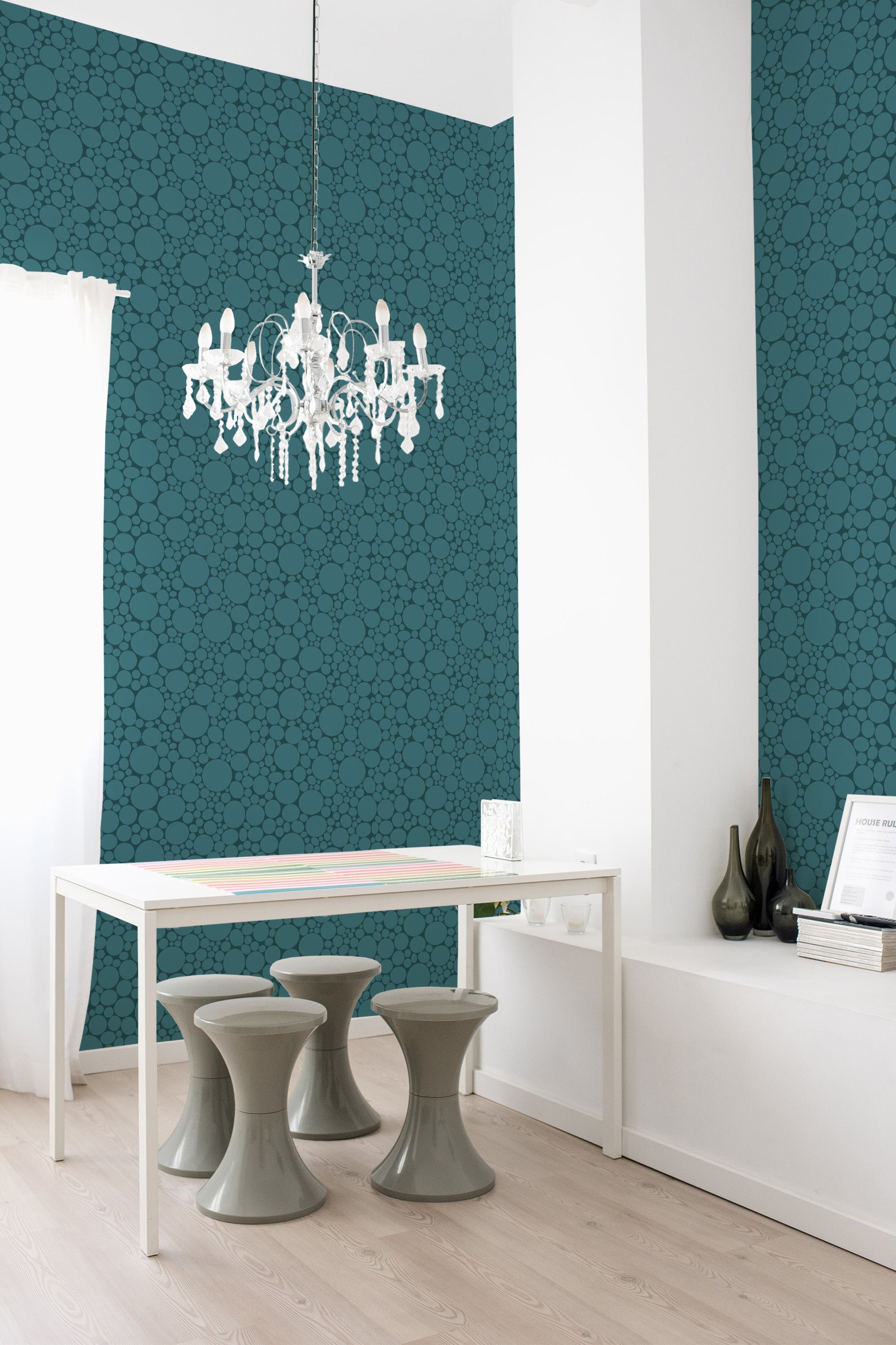 The wallpaper design is a rich teal hue adorned with scattered circular patterns, creating a modern yet classic aesthetic. The intricate design adds textured depth to the walls of the room, balancing contemporary style with a nod to traditional wallpaper.