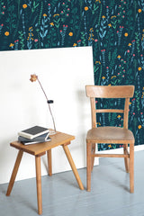 Self-adhesive dark blue wallpaper with a meadow design, adorned with small, colorful wildflowers and delicate green foliage, adding a vibrant yet calming touch to the room.