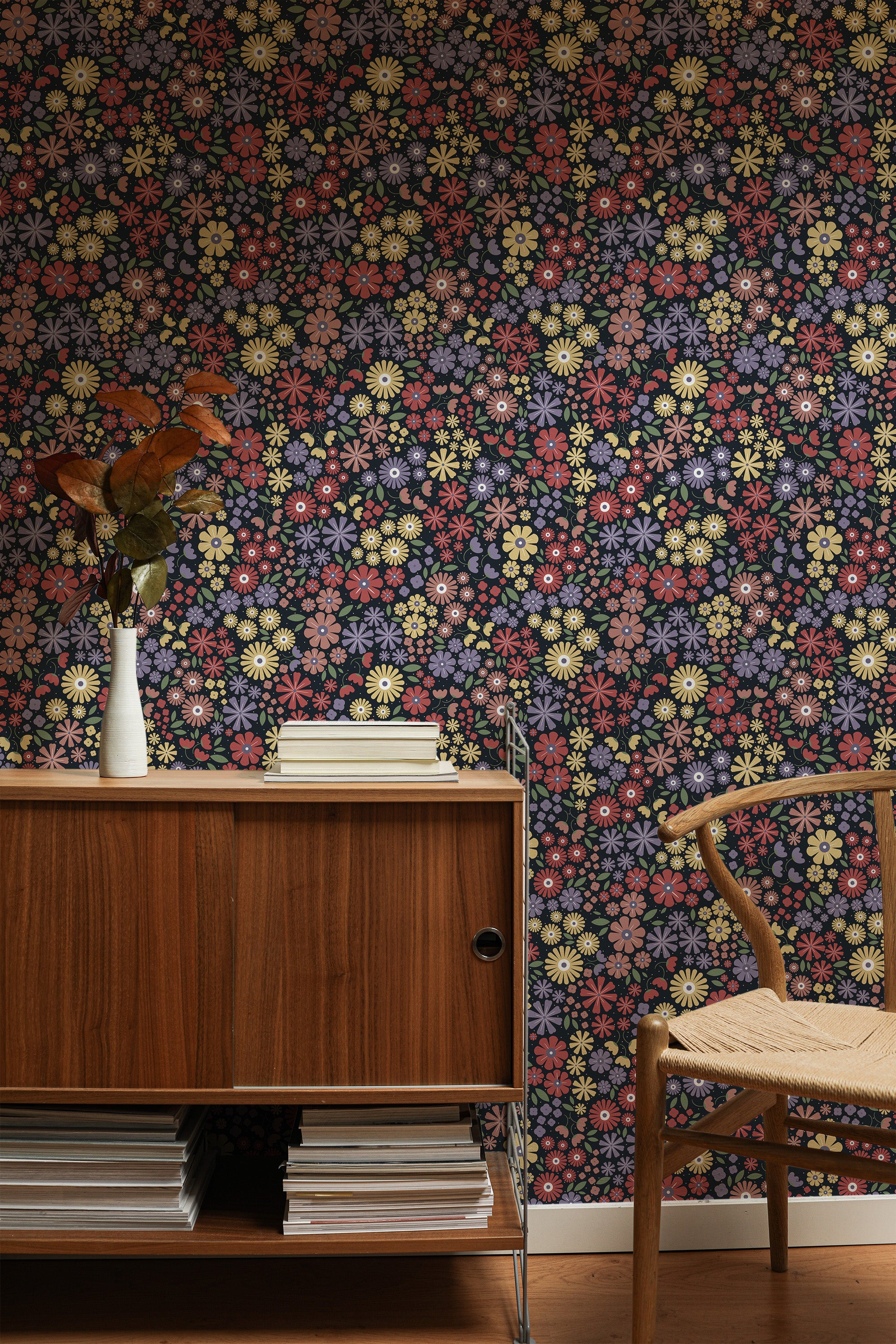 Self-adhesive wallpaper with a colorful small floral pattern featuring a mix of vibrant flowers in shades of pink, yellow, purple, and white against a dark background.