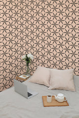 Self-adhesive wallpaper with a Beige stars tile design, creating a geometric pattern on a soft peach-colored background.