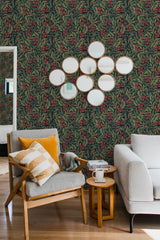Green and red Christmas-themed wallpaper with intricate botanical patterns, including holly leaves and berries, in a repeating design. Traditional wallpaper.