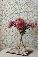 Self-adhesive wallpaper with a watercolor design of green and olive leaves, accented by scattered red berries on a cream background.