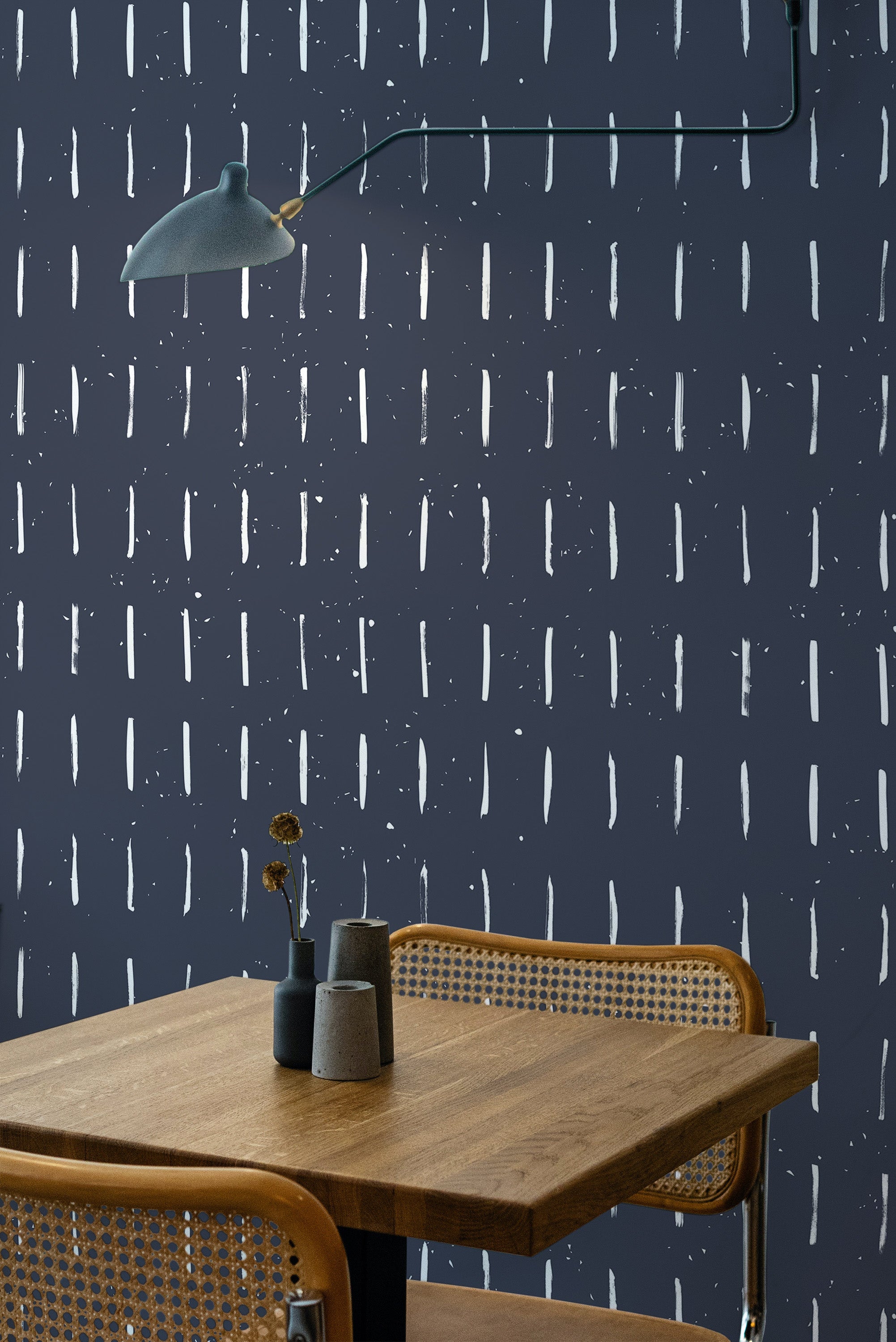 Self-adhesive Navy brush stroke wallpaper with white vertical strokes creating a modern, abstract pattern behind a cozy wooden table and chairs.