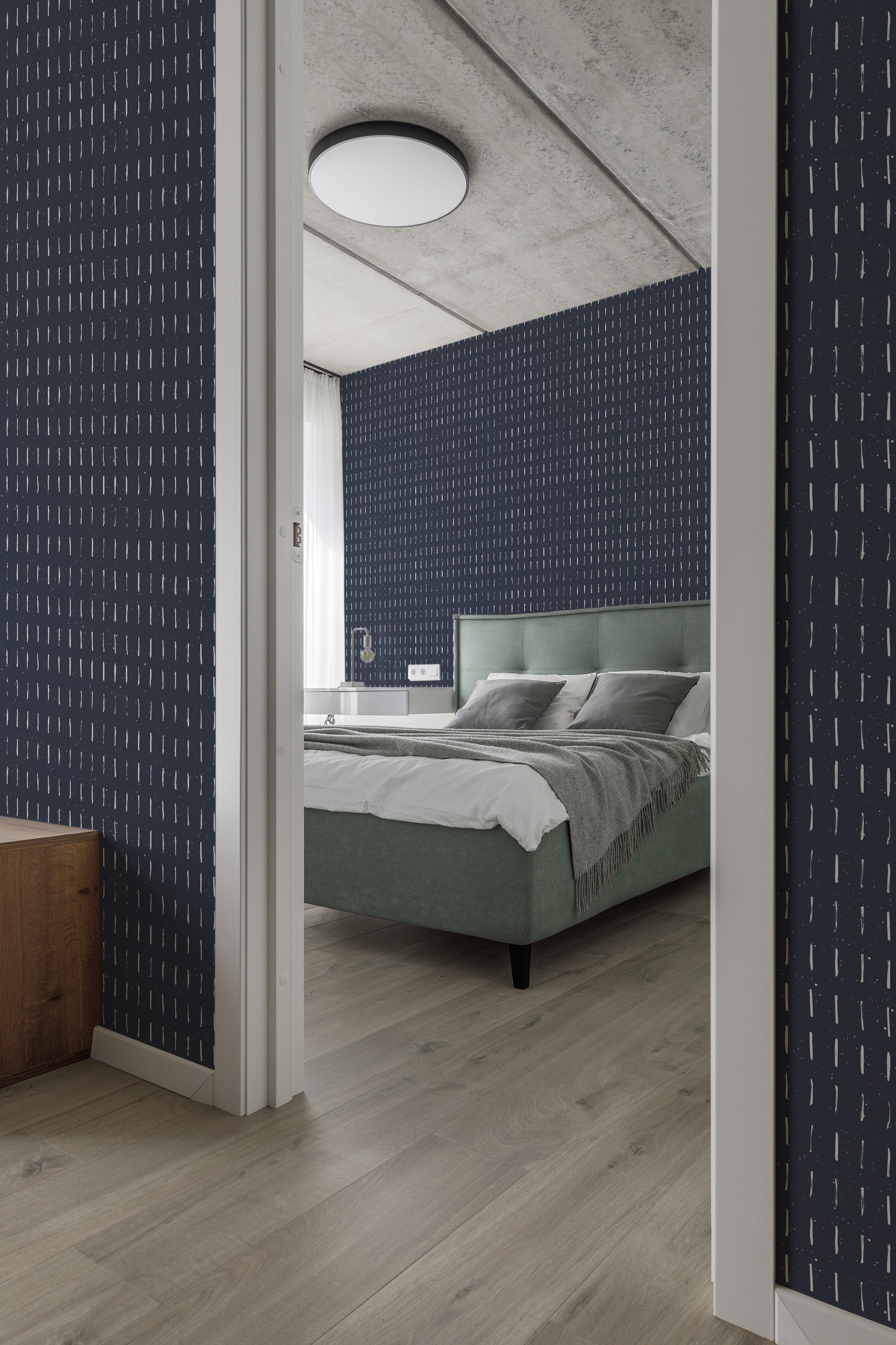 Navy wallpaper with thin, uneven vertical brush stroke patterns in white, creating a dynamic and modern look in a bedroom with traditional wallpaper.