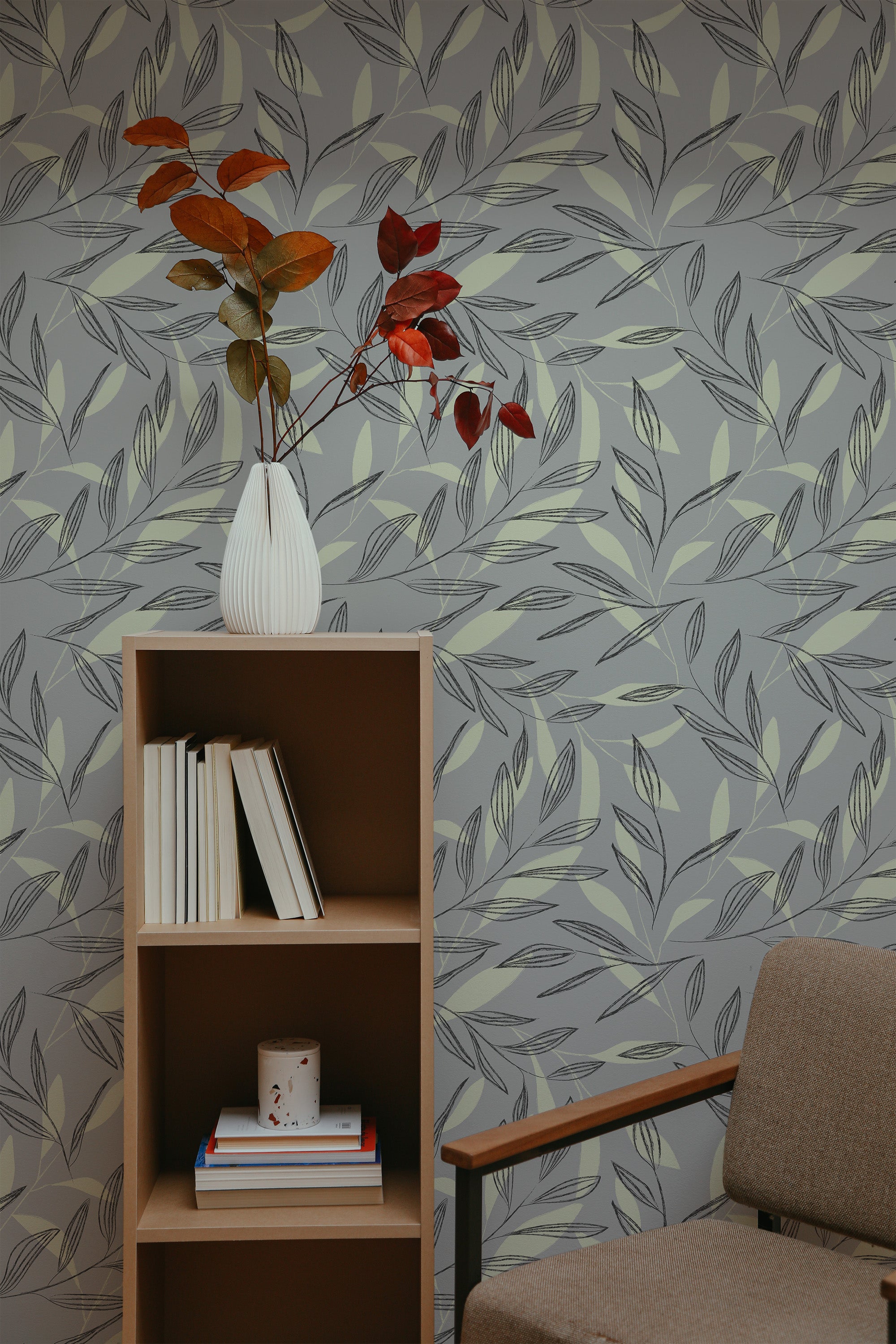 Self-adhesive wallpaper with a neutral leaf stencil design in muted tones of grey and green. The pattern includes various leaf shapes scattered across the wall, creating a natural and subtle backdrop.