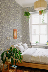 Wallpaper adorned with a pattern of delicate, neutral-colored leaves intricately arranged across the wall, creating a subtle yet elegant textured appearance. The traditional wallpaper.