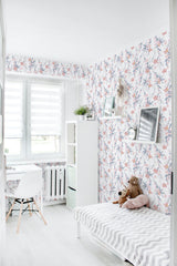 Room with watercolor flower wallpaper, featuring delicate pastel-colored blossoms and subtle green leaves on a white background, traditional wallpaper.