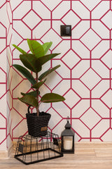 Self-adhesive wallpaper with a viva magenta tile pattern featuring interconnected geometric shapes on a white background, adding a modern and bold touch to the room.