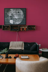 A room with walls covered in Solid Viva Magenta wallpaper, a rich and bold magenta color that adds vibrancy to the space, traditional wallpaper.