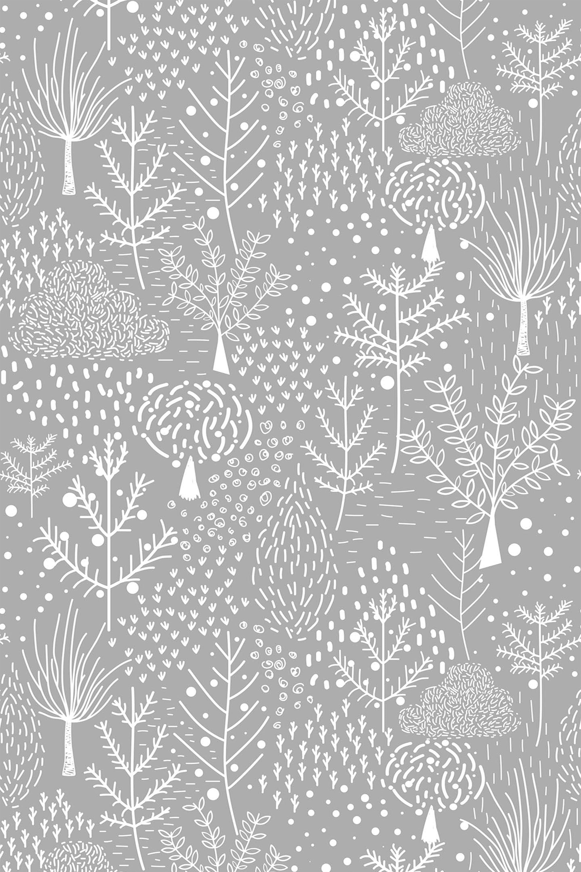 Illustration of white, stylized trees and foliage scattered across a gray background, creating a winter forest pattern. Various tree shapes, clusters of leaves, and small dots mimic snowfall, evoking a serene snowy forest scene. Peel and stick removable wallpaper.