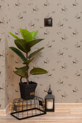 Self-adhesive wallpaper with a hunting dog design in subtle brown tones, showing dogs in various action poses among grass and birds.
