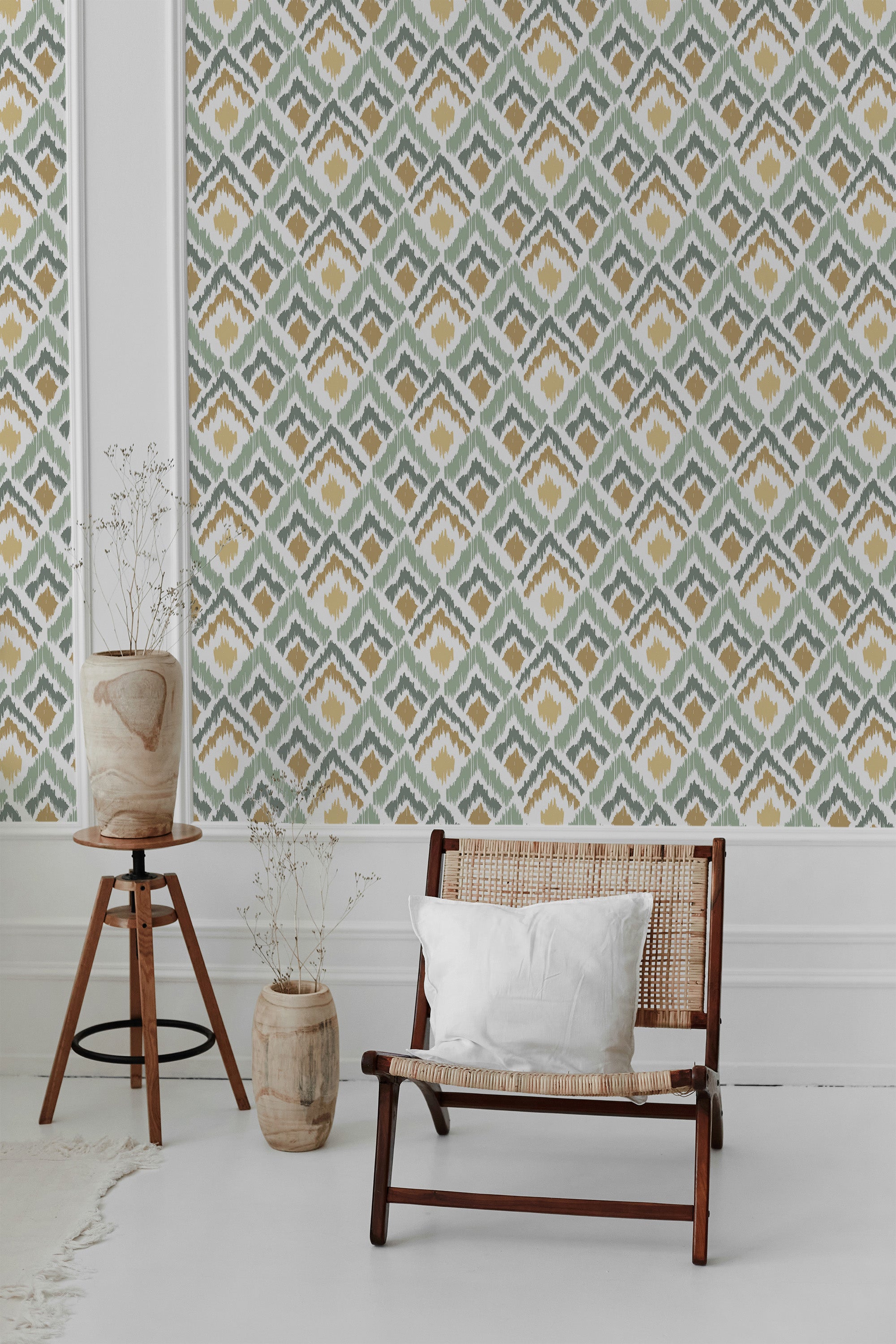 A room with green ikat-patterned wallpaper, characterized by diamond shapes and muted tones of green, yellow, and white, adding a subtle, textured look. Traditional wallpaper.