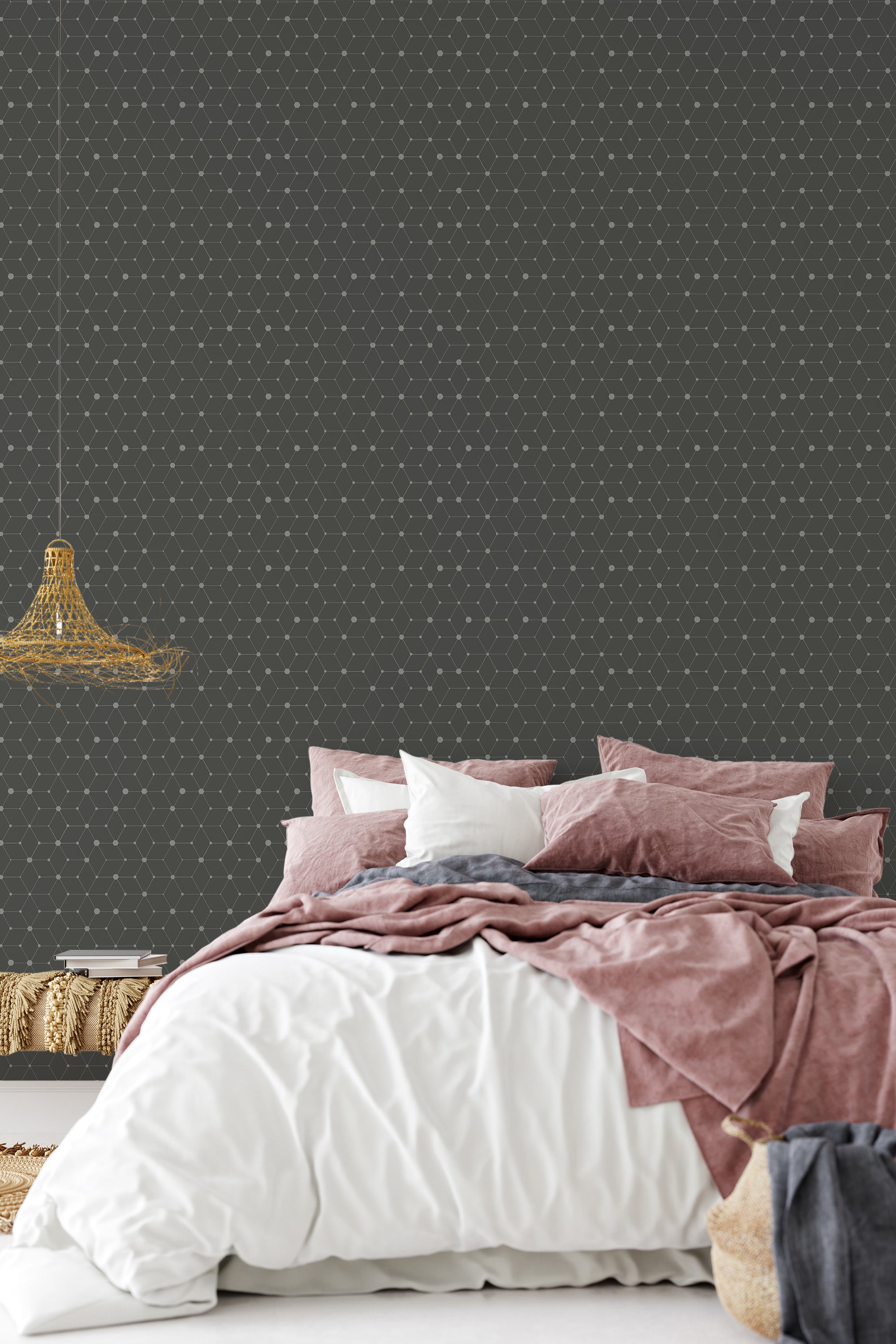 A room with dark geometric dot-patterned wallpaper in a subtle, repetitive design above a bed with soft pink and white bedding. Traditional wallpaper.