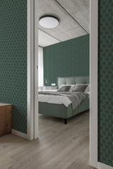 Emerald green art deco wallpaper with geometric lines forming intricate patterns creating a stylish, vintage atmosphere in a contemporary bedroom lit by natural light. Traditional wallpaper.