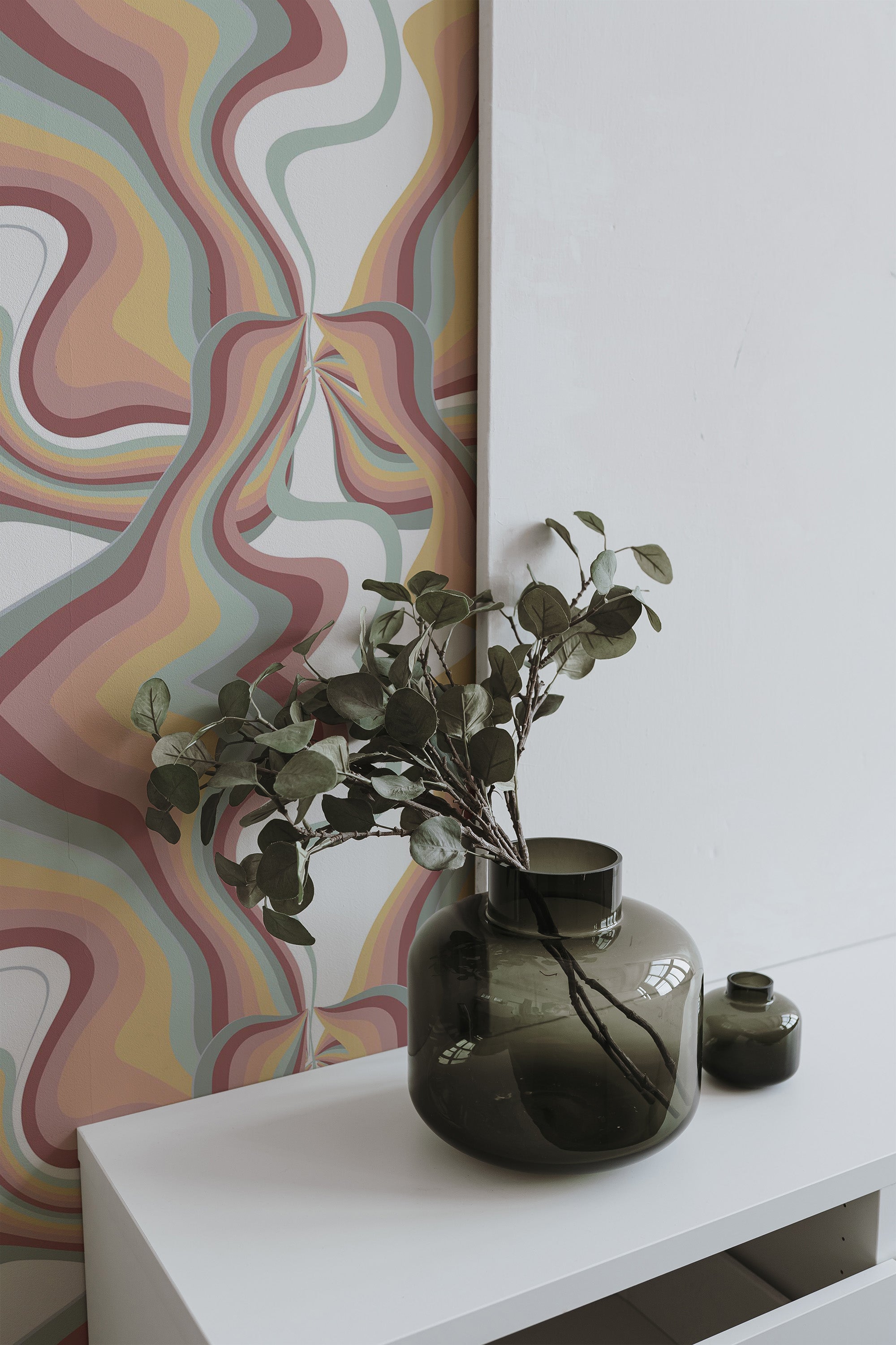 Self-adhesive wallpaper with an Earthy psychedelic design, featuring wavy abstract patterns in muted tones of pink, beige, green, and yellow.