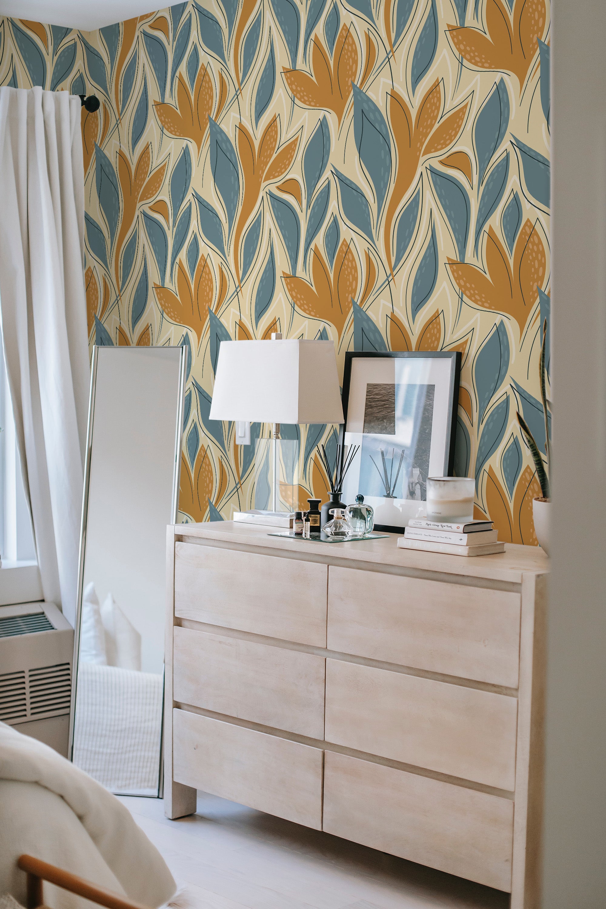 A room with walls covered in a blue abstract leaf design, combining rich earthy tones of mustard yellow and muted blue against a soft beige background, emphasizing organic shapes and soft lines reminiscent of foliage, adding a warm and modern touch to the space. Traditional wallpaper.
