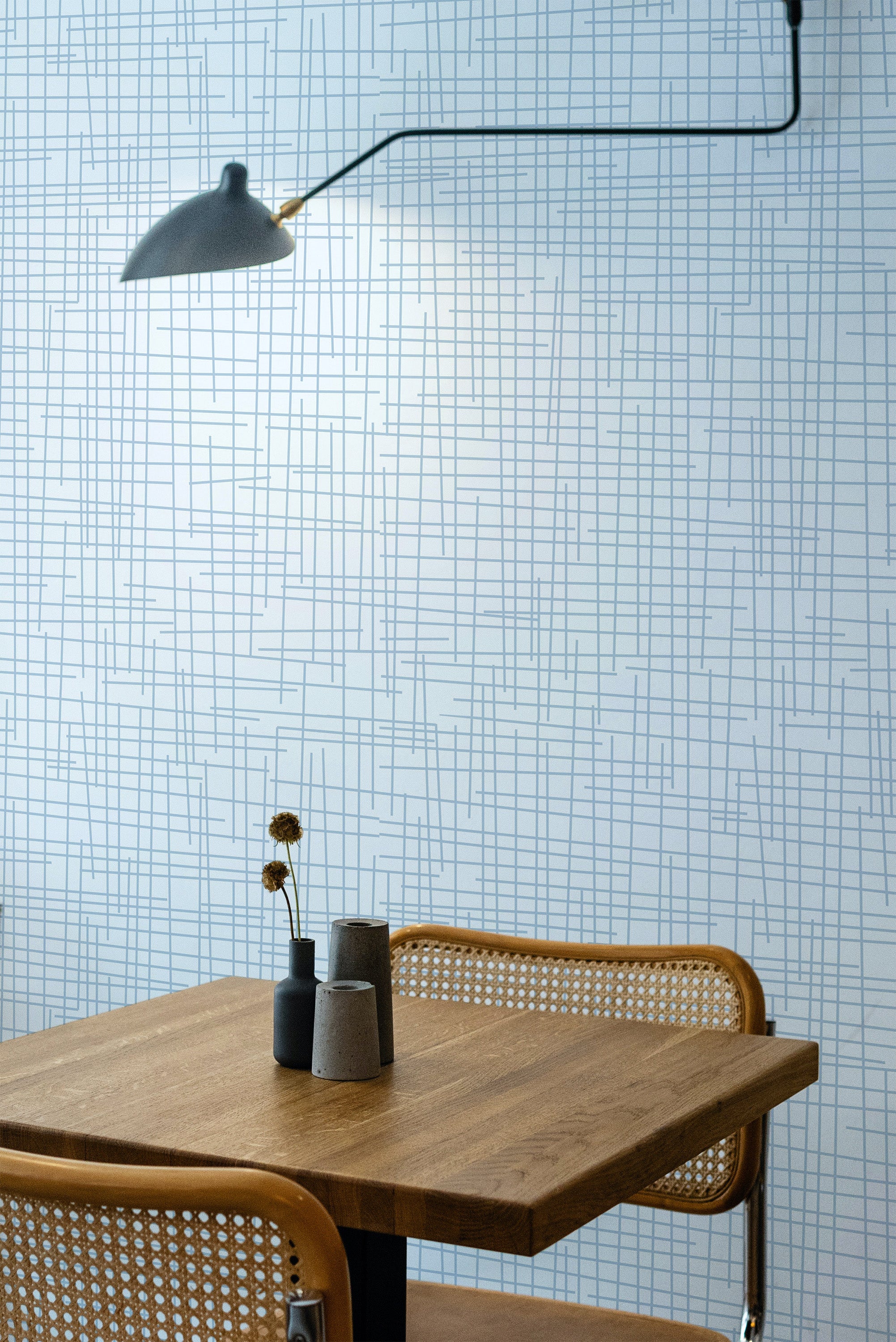 Self-adhesive wallpaper with a light wash denim design, featuring a subtle blue grid pattern over a white background, adding a modern touch to the room.