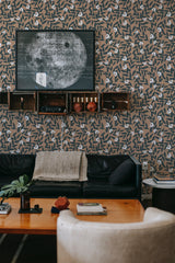 A room with brown wallpaper adorned with an eclectic leaf pattern in various shades of brown and white. Traditional wallpaper.