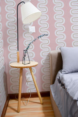 Self-adhesive Pink Eclectic Wave wallpaper with a retro-inspired, continuous curved pattern in white on a soft pink background, creating a stylish and modern ambiance in the room.
