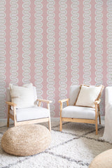 Wallpaper with a wavy, repeating geometric pattern in soft pink and neutral tones, creating a vintage aesthetic. Traditional wallpaper.