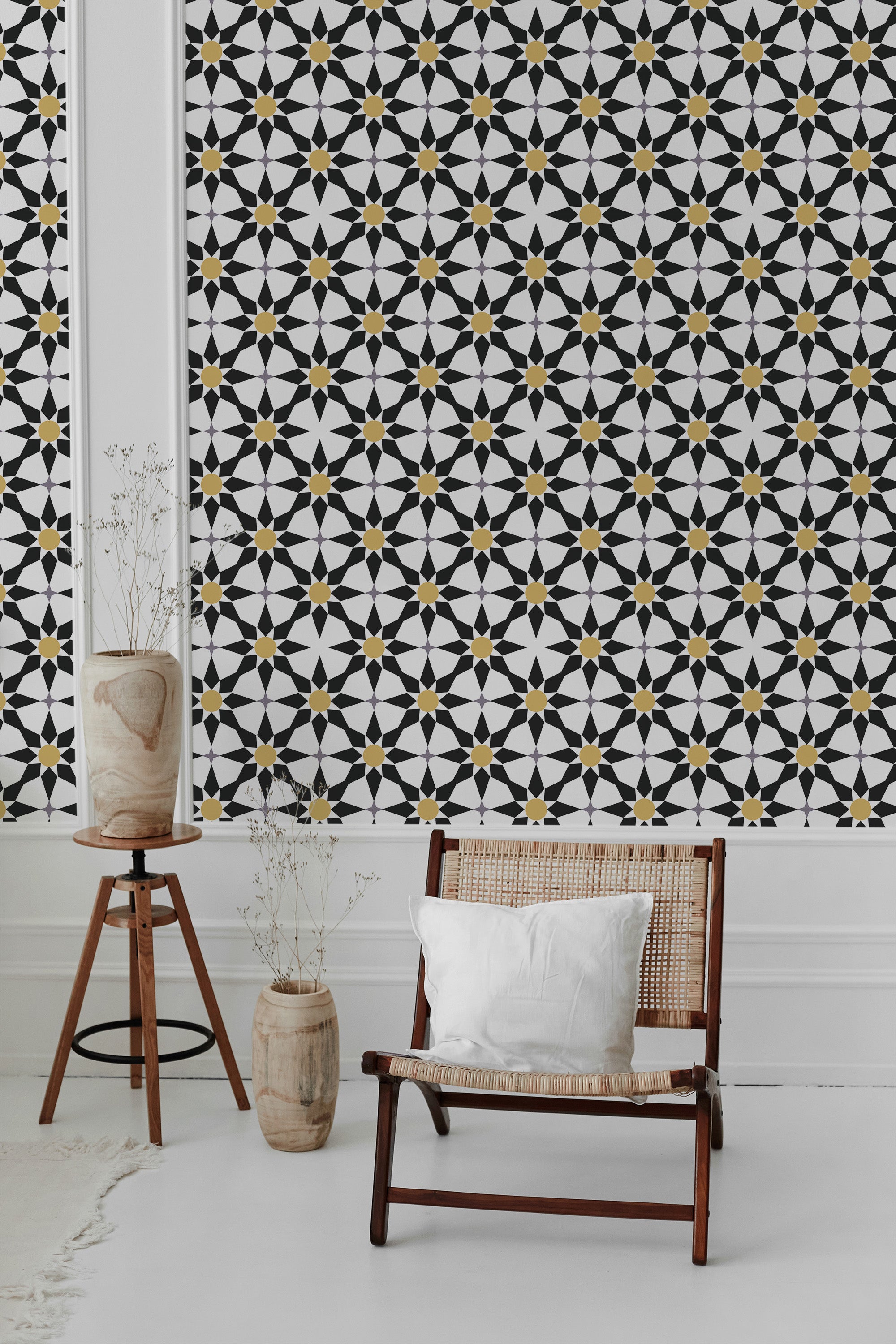 A room with wallpaper featuring a pattern of black star-shaped tiles interspersed with small yellow accents, creating a geometric design against a white background. It is traditional wallpaper.
