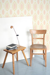 Self-adhesive wallpaper with a pink vintage circle design, featuring repeating oval shapes formed by soft yellow and pink lines.