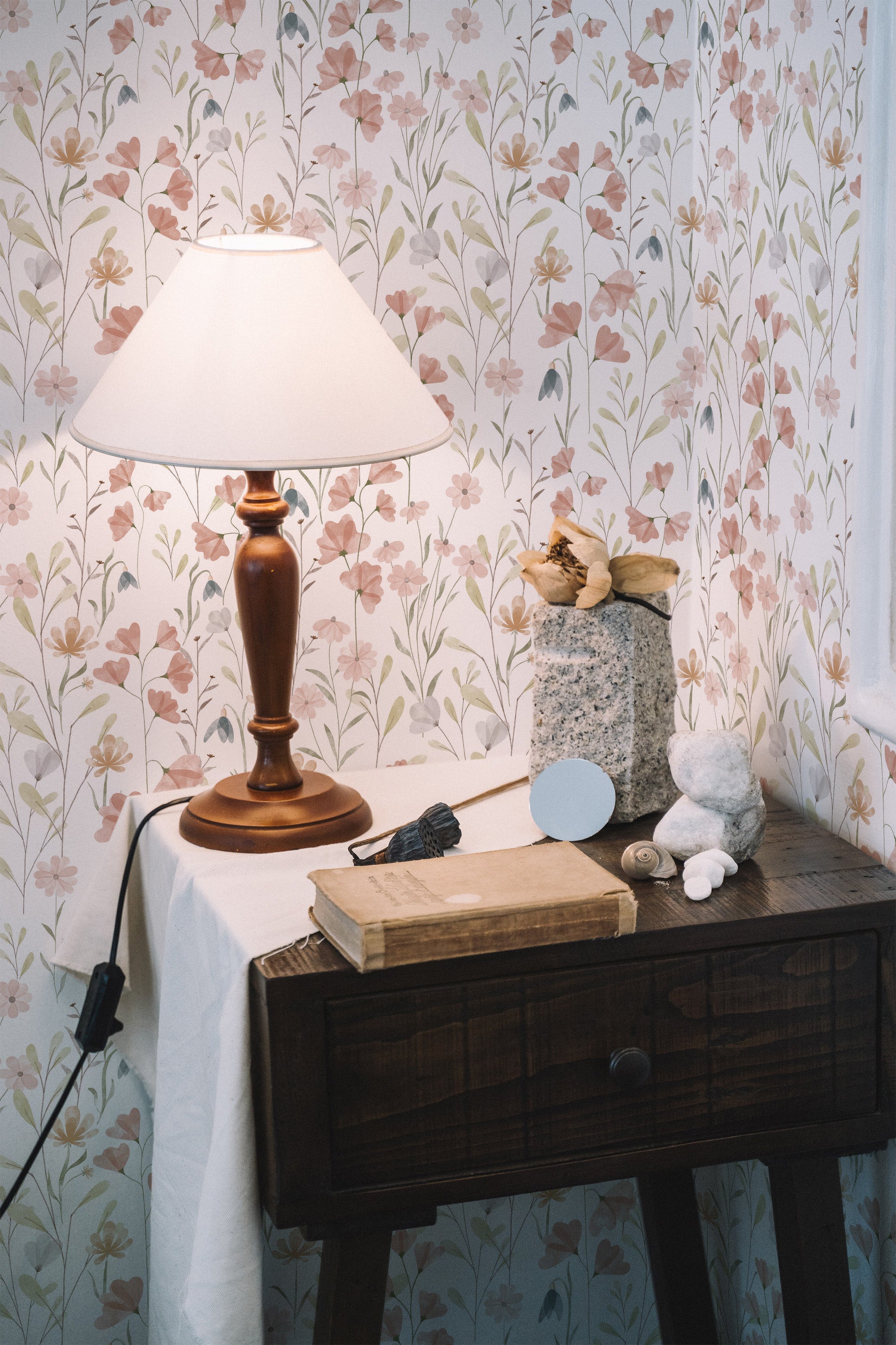 Self-adhesive wallpaper designed with soft, pastel-colored floral patterns, including delicate watercolor-like flowers and leafy stems that evoke a gentle, springtime feel.