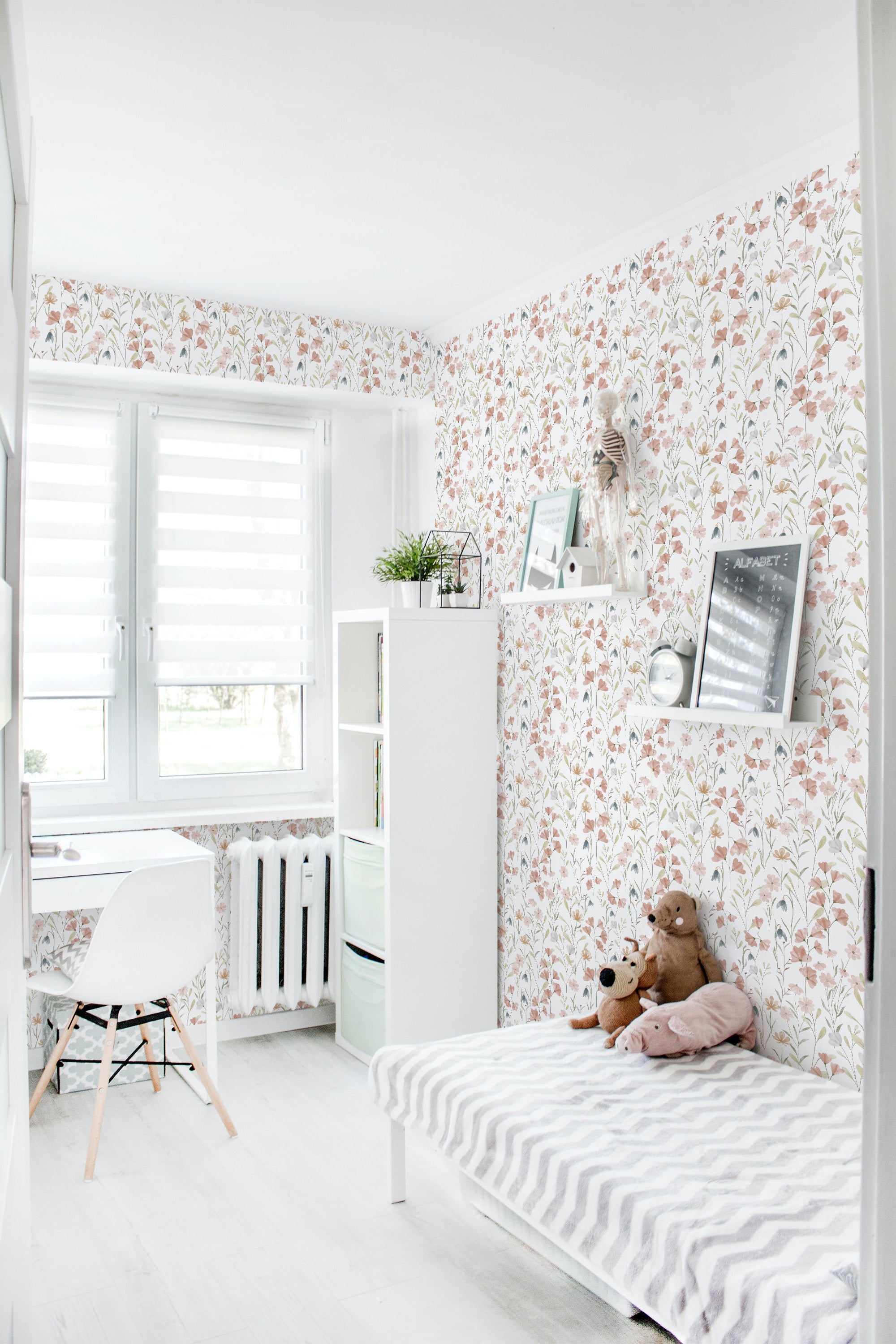The room has walls covered in a delicate Watercolor Spring wallpaper design with soft floral patterns of pink, green, and beige hues, creating a fresh and airy atmosphere. The design adds a gentle, natural touch, blending modern and classic elements, in traditional wallpaper.