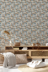 The wallpaper design has a repeating pattern of oval and rectangular shapes in muted tones of blue, brown, tan, and beige, creating a retro aesthetic reminiscent of mid-century modern style. Traditional wallpaper.
