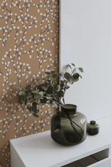 Self-adhesive wallpaper with a Willow branches pattern in white and beige hues, highlighting delicate, intertwined branches with rounded leaves against a warm, earthy background.